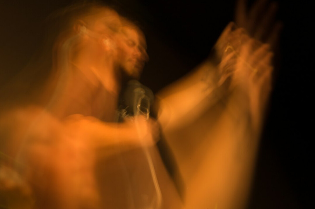 Close-up of a microphone with warm blurred stage lights