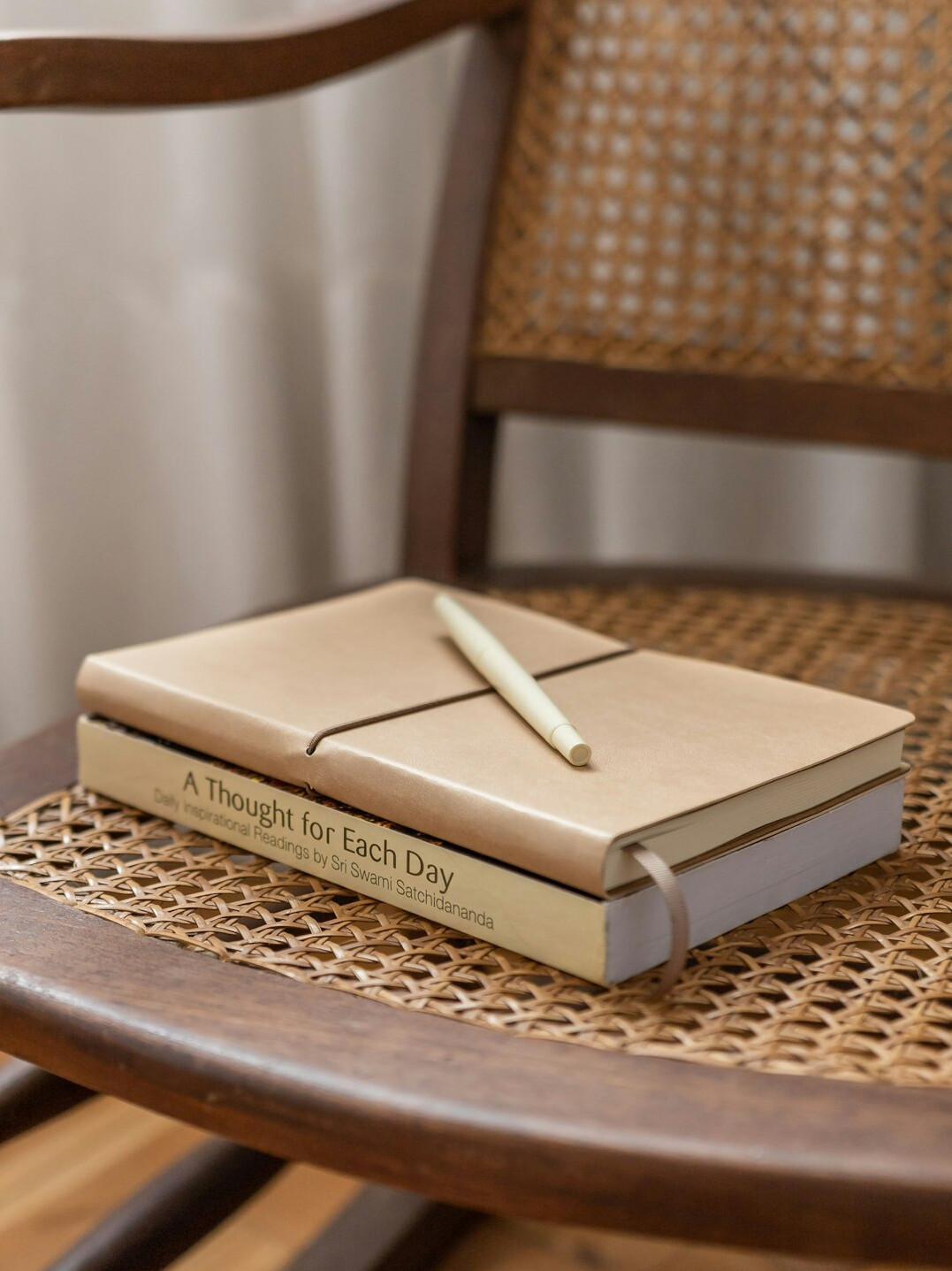 Open notebook with handwritten notes and a pen on a desk
