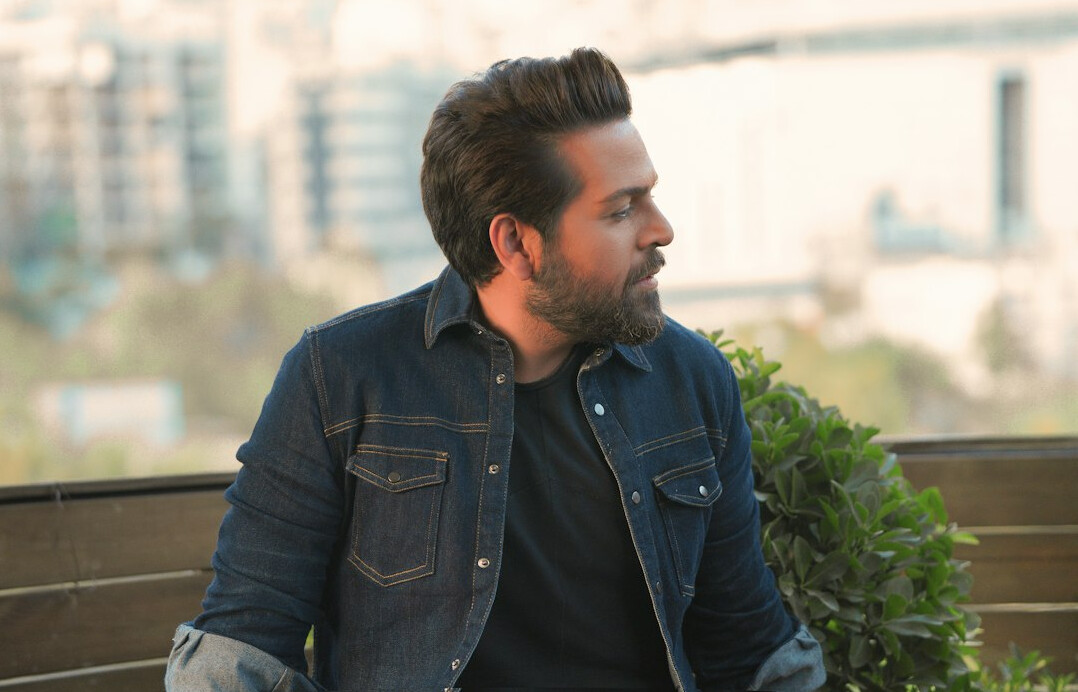 Smiling man with a light beard in a casual shirt