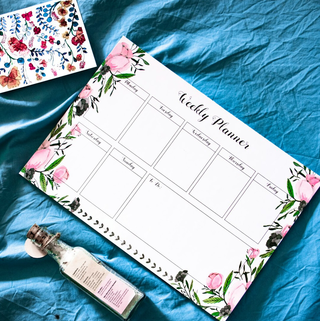 Weekly planner and pen on a desk